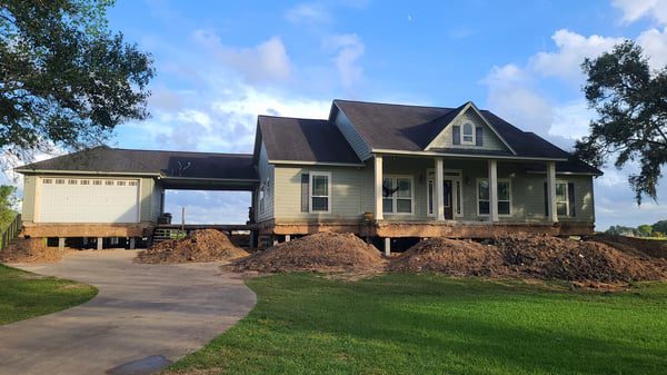 a house is being built in the middle of a field