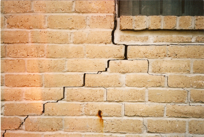 a brick wall with a crack in it