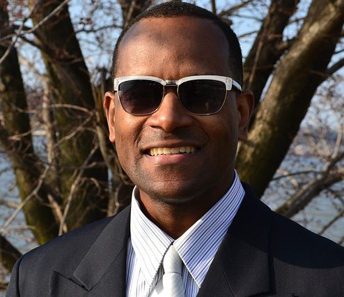 a man in a suit and tie wearing sunglasses