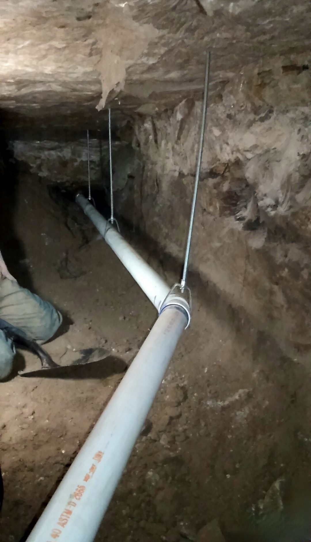 a man is standing in a tunnel with a hose