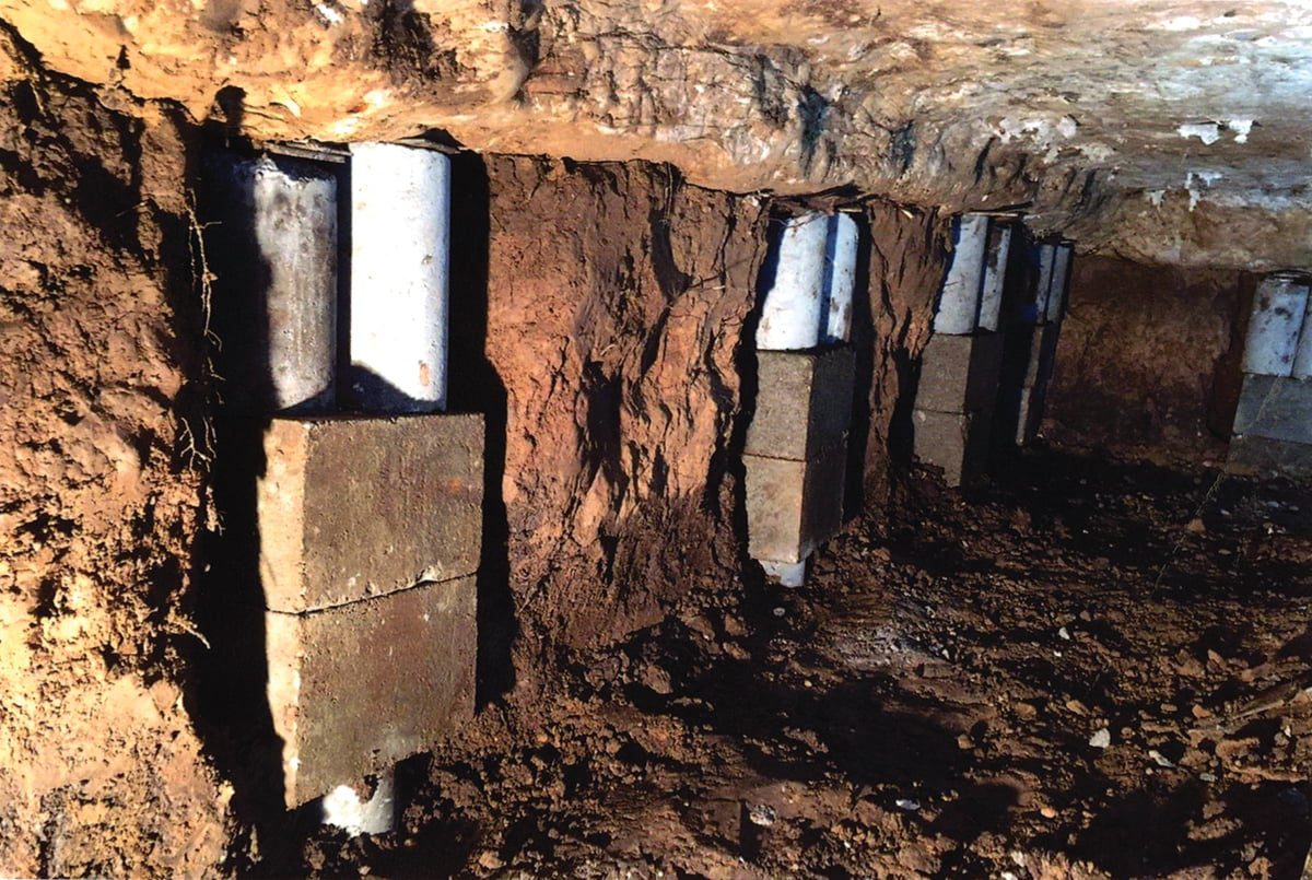 a group of metal pipes in a cave