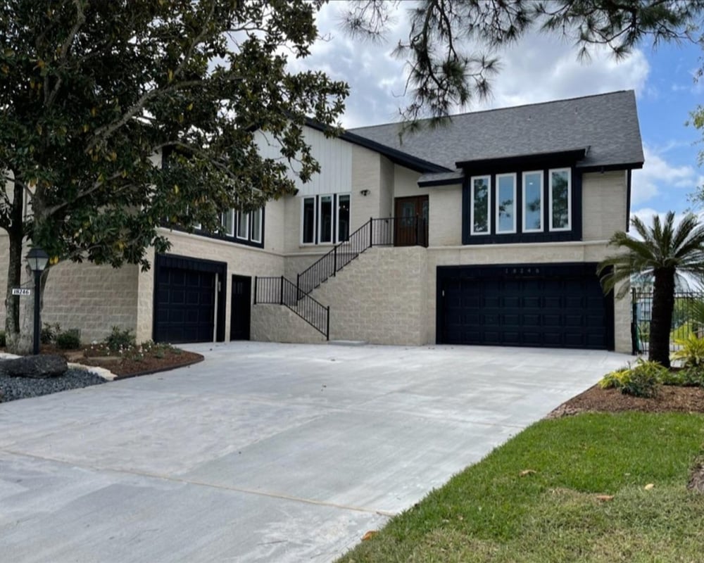 a large house with two garages on the side