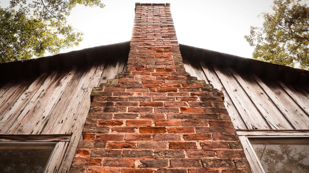 a brick chimney on the side of a building