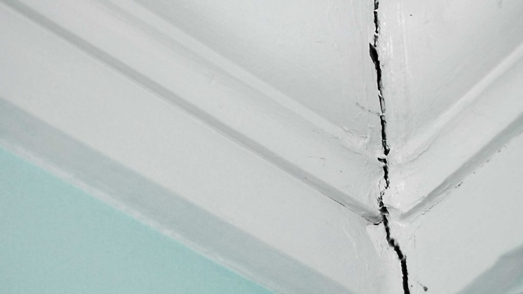 a crack in the ceiling is shown with white paint