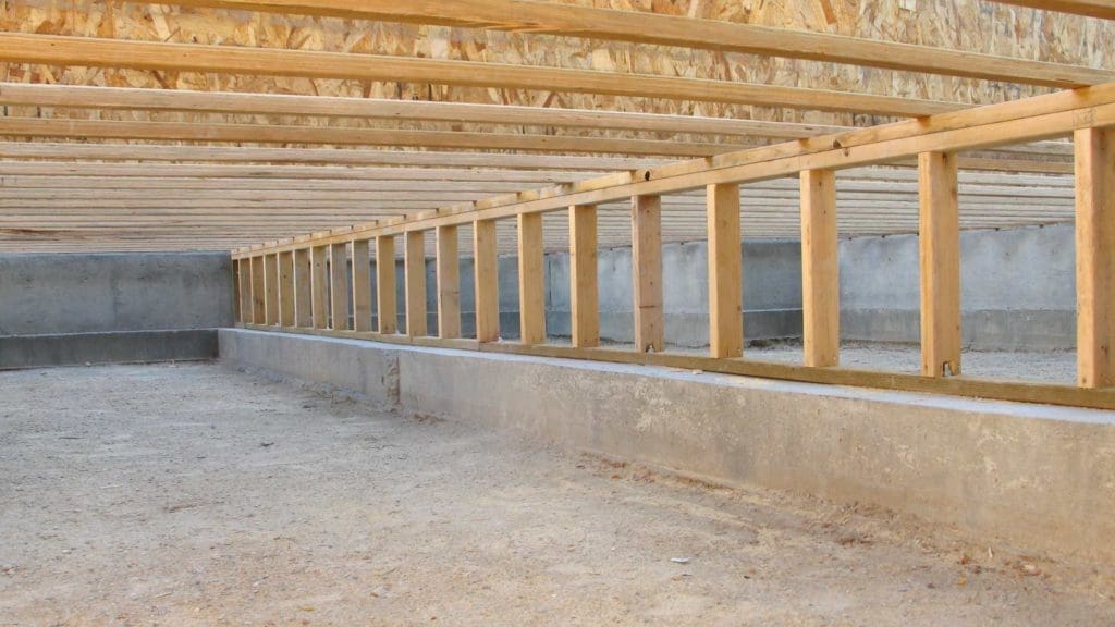 an unfinished building with wooden beams and walls