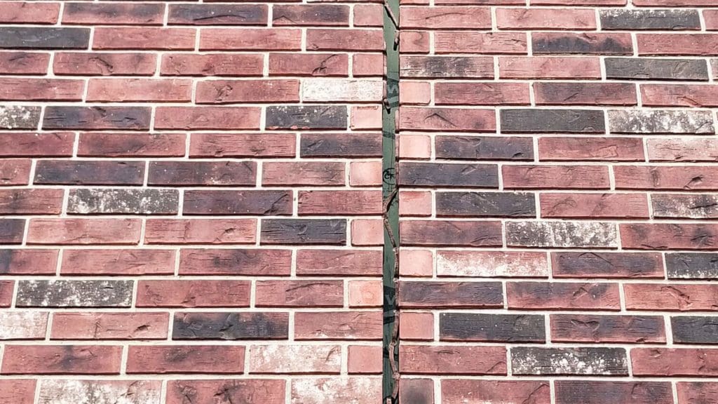 a red brick wall with a clock on it