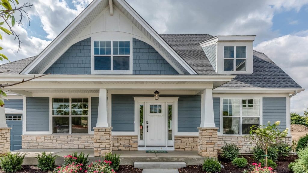 a blue house with white trim and windows