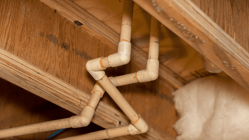 a close up of a wooden structure with pipes