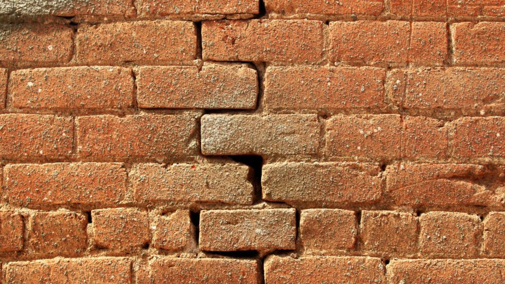 a brick wall with a crack in it