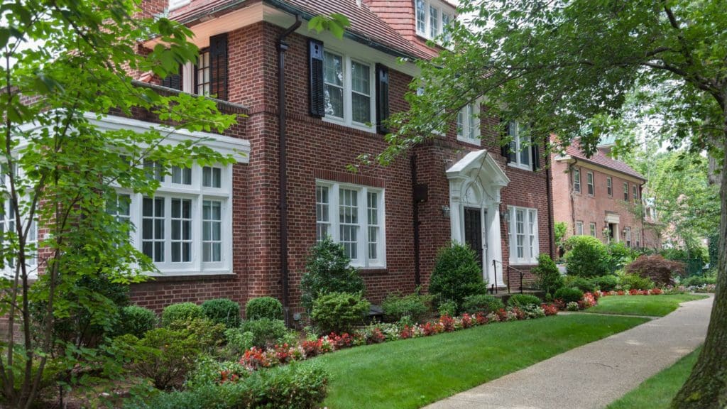 a brick house with white trim and windows