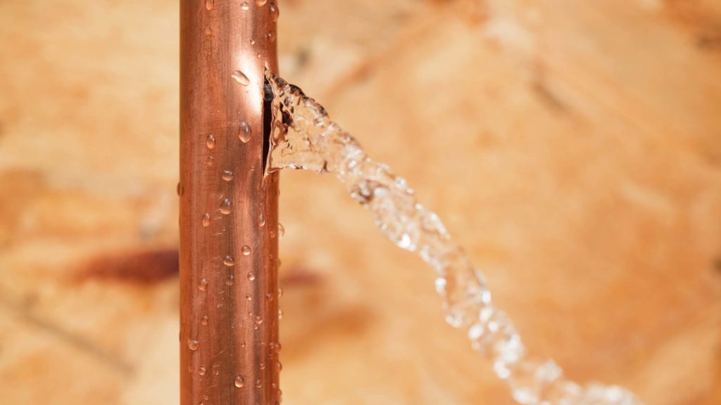 a close up of a metal pipe with water coming out of it