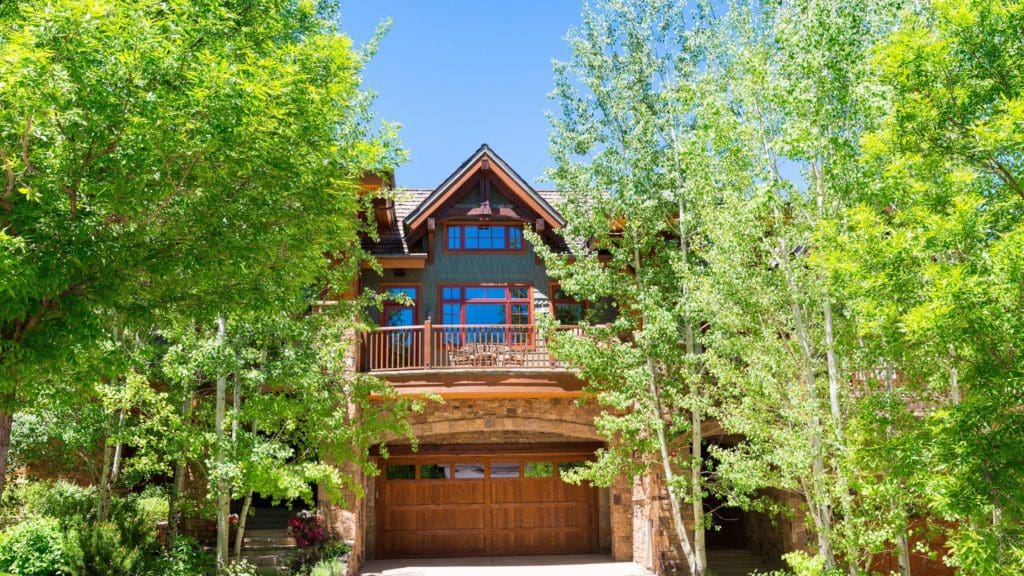 a large house surrounded by trees and bushes