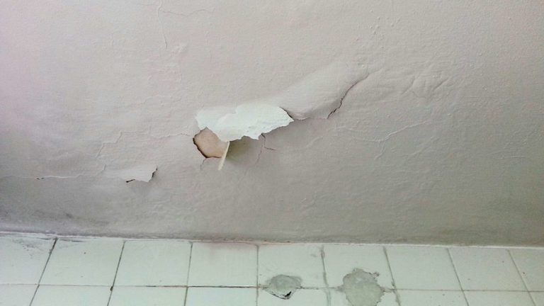 a bathroom wall that has been torn down
