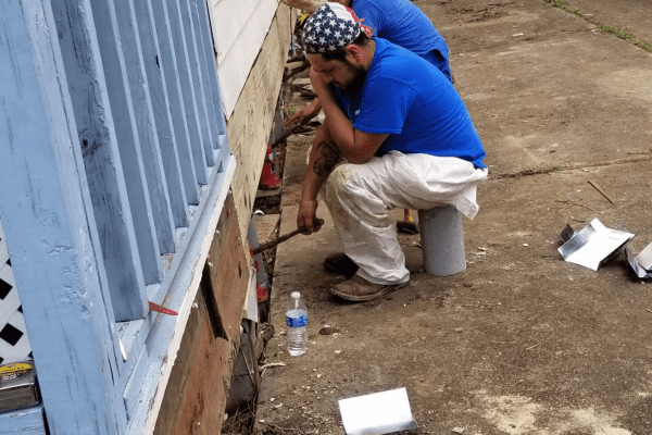 man working on flooded home