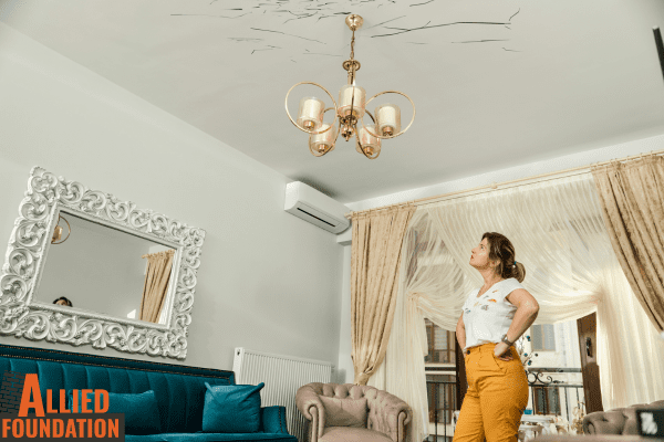 a woman standing in a living room next to a couch